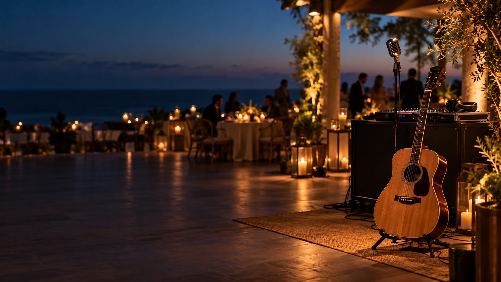 Acoustic guitar, microphone and DJ equipment at a coastal evening event
